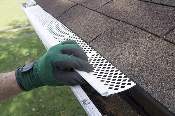 gutter guards prevent clogs by blocking leaves, twigs, and other debris from entering the gutter